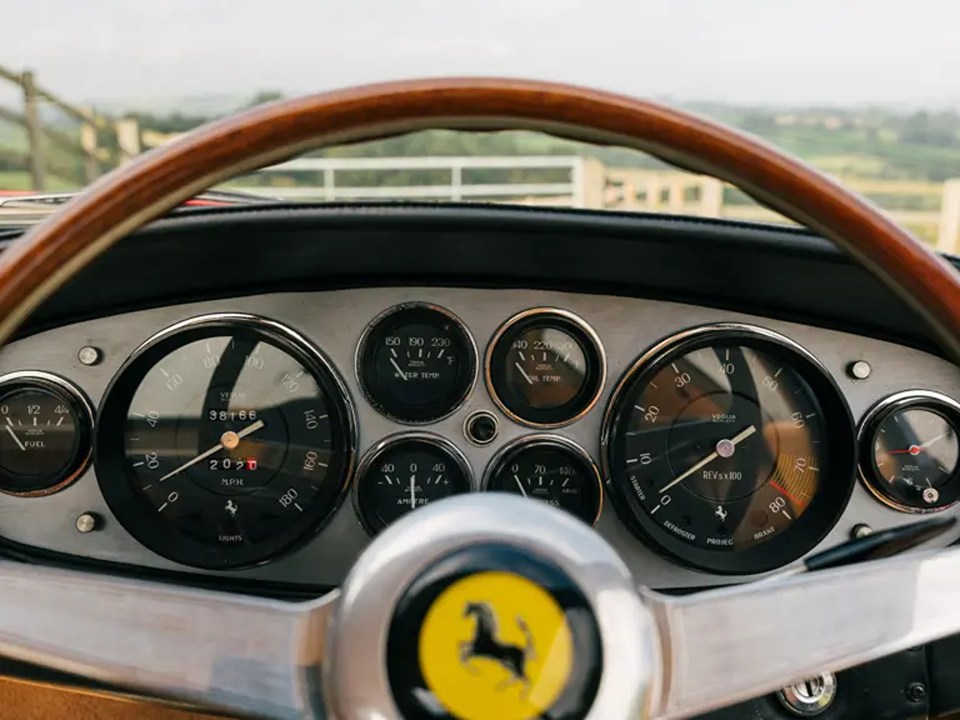 a dashboard of a ferrari with a horse on the steering wheel