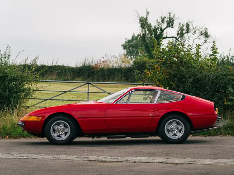 a red sports car is parked on the side of the road