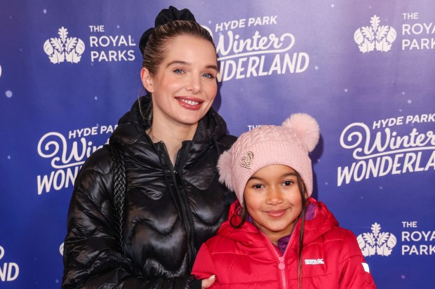 a woman and child pose for a photo in front of a hyde park winter wonderland sign