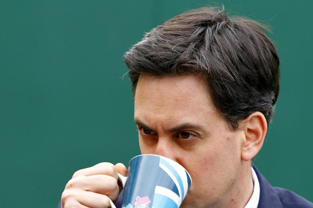 a man drinking from a cup with a british flag on it