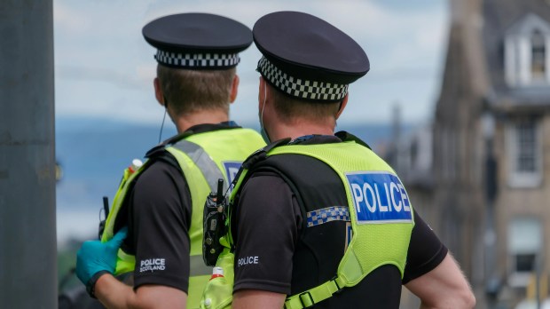 two police officers are standing next to each other