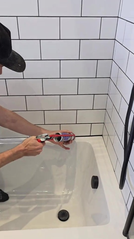 A man has divided opinion after using black grout and sealant to jazz up his bathroom