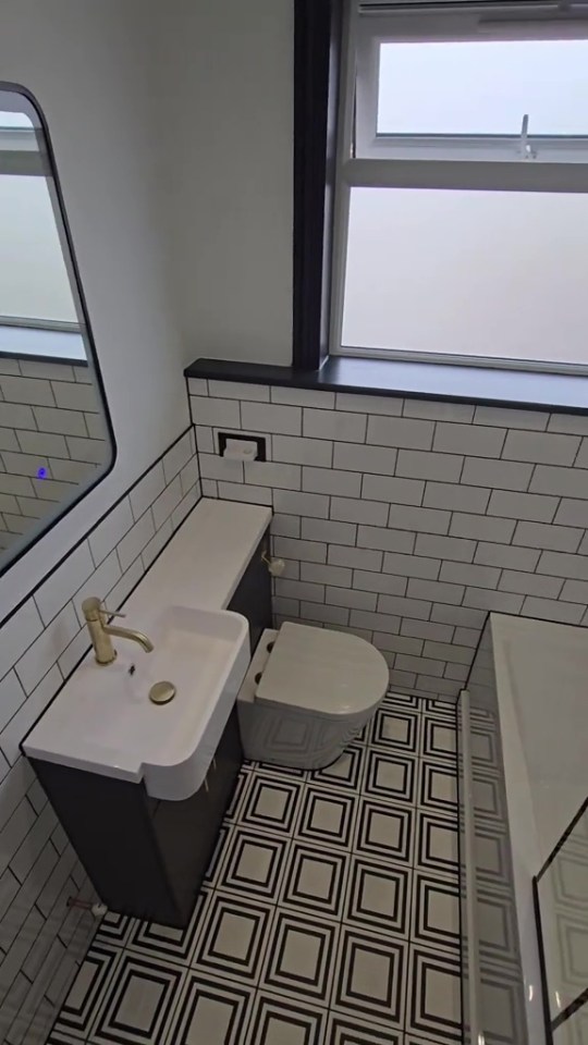 With the black on the walls meant to complement the monochrome floor tiles