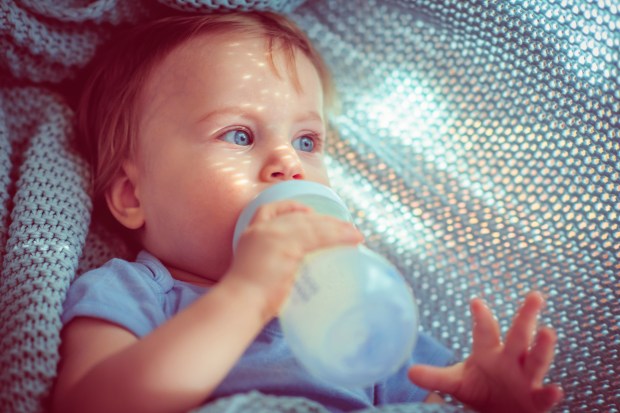 a baby drinking from a bottle that says ' philips ' on it