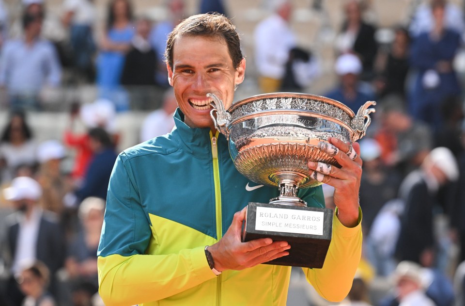 a man holding a trophy that says roland garros simple messeurs