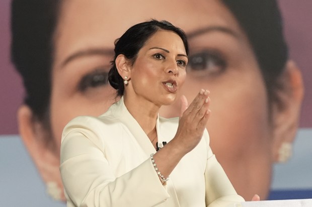 a woman in a white jacket is giving a speech