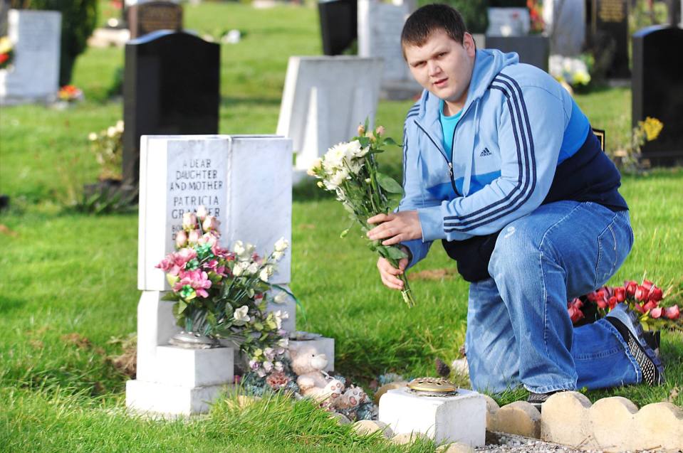 Danny, 32, visiting his late mother's tombstone