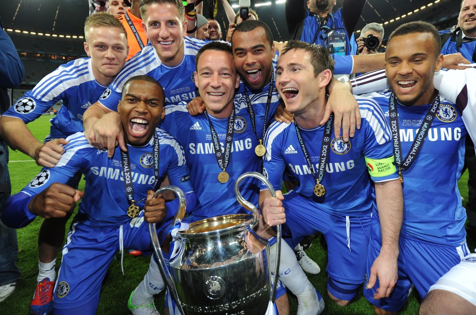 a group of soccer players wearing samsung jerseys celebrate with the trophy