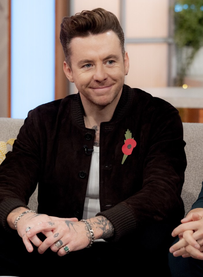 a man with a poppy pin on his jacket