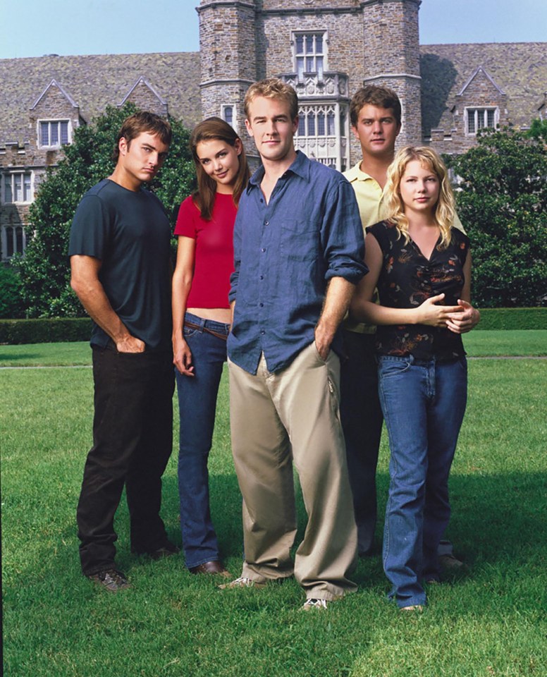 a group of people standing in front of a stone building