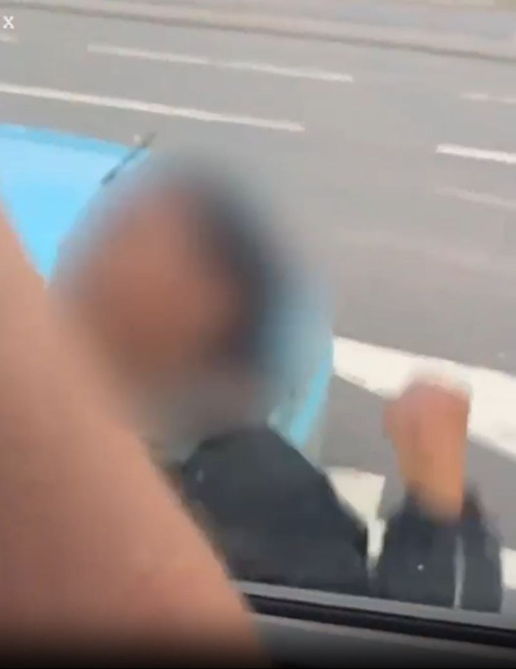 Multiple punches appeared to be thrown as shocked motorists watched on