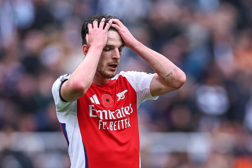 soccer player wearing a red emirates fly better jersey