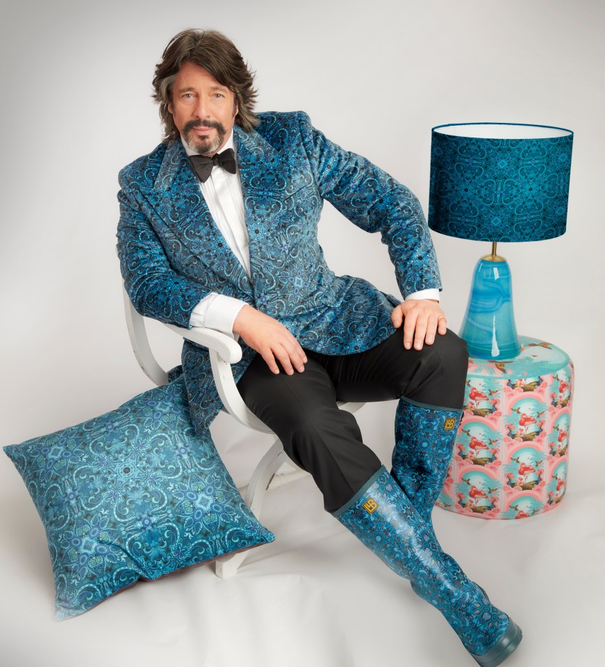 a man in a blue suit sits in a chair