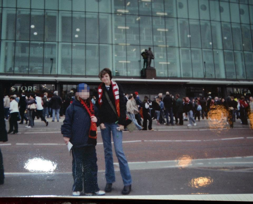 two people standing in front of a store that says mega