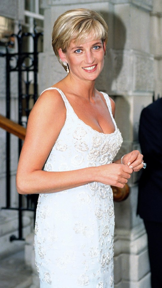 a woman in a white dress is smiling for the camera