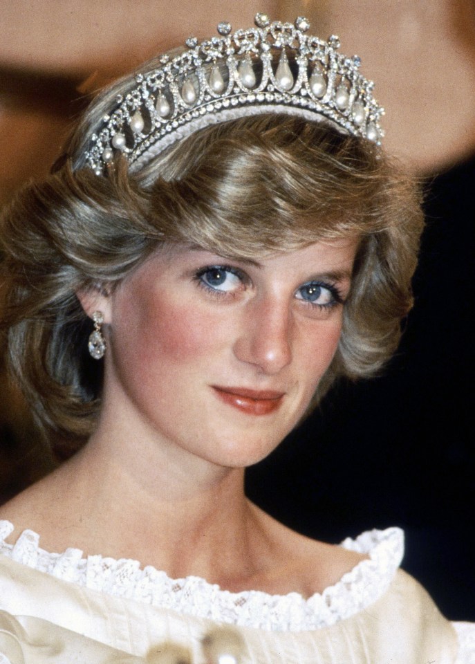 Diana, Princess of Wales, wearing a cream satin dress attending a banquet in New Zealand