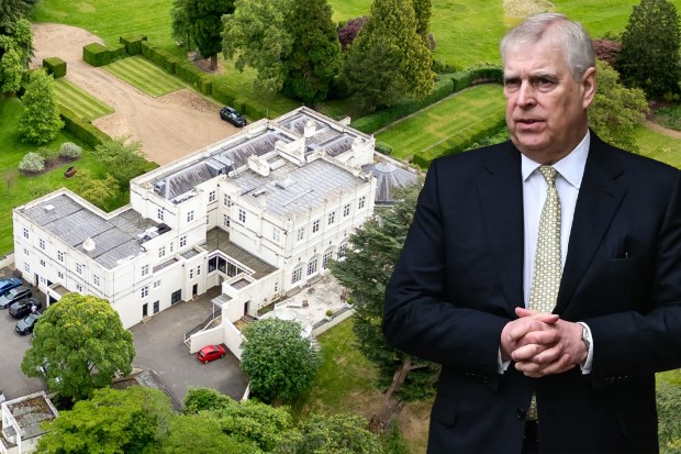 a man in a suit and tie stands in front of a large white building