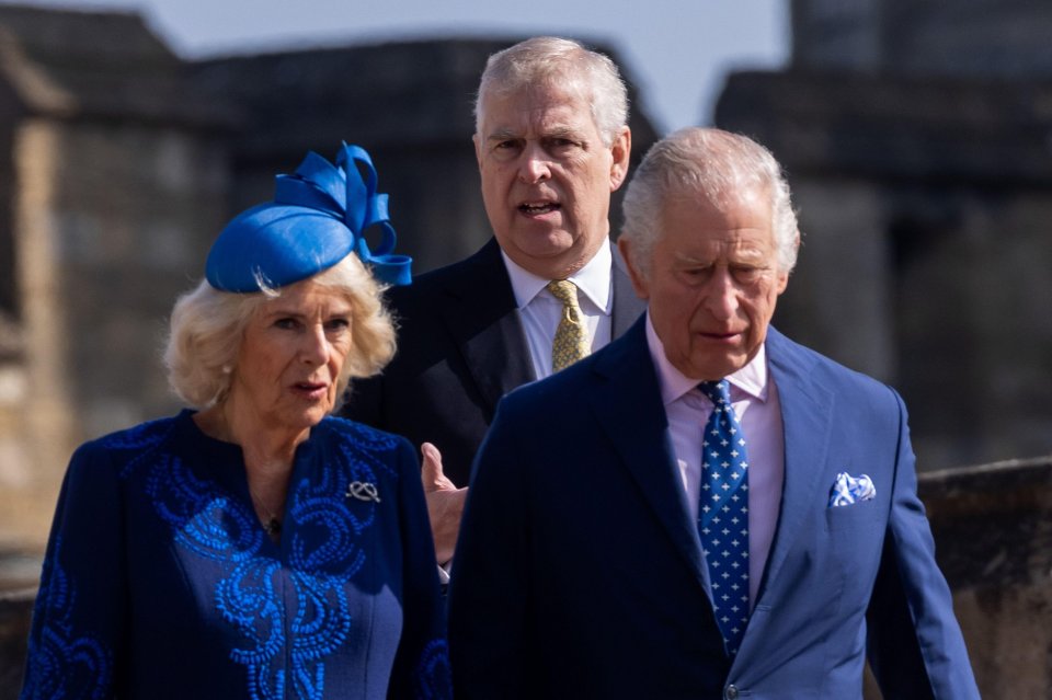 a woman in a blue hat stands next to two men in suits