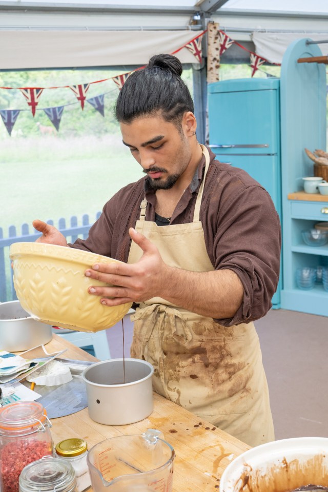 a man in an apron is pouring chocolate into a bowl