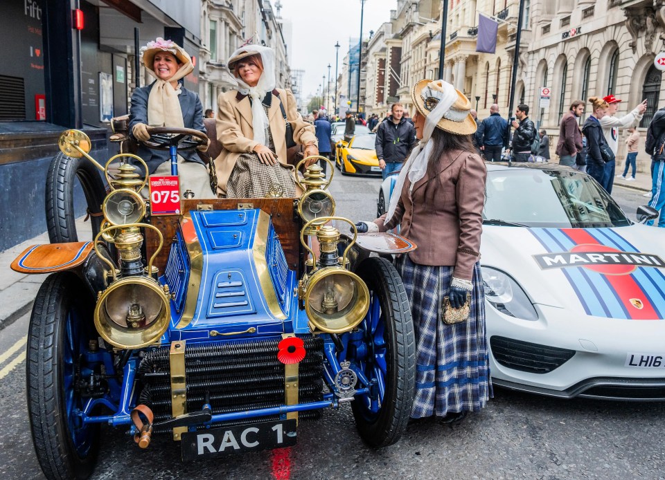 A pair of veteran car enthusiasts perch on a 1901 Mors