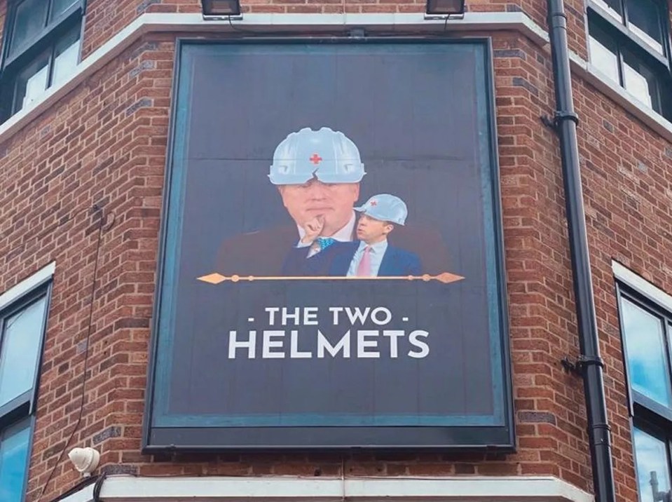 a billboard on the side of a building advertises the two helmets