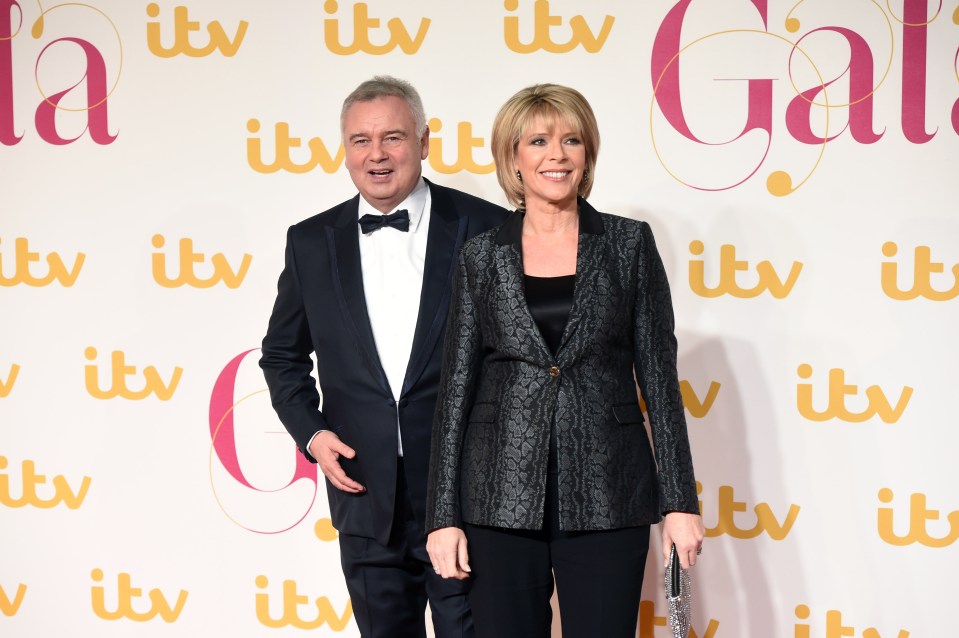 a man and woman standing in front of a wall that says itv