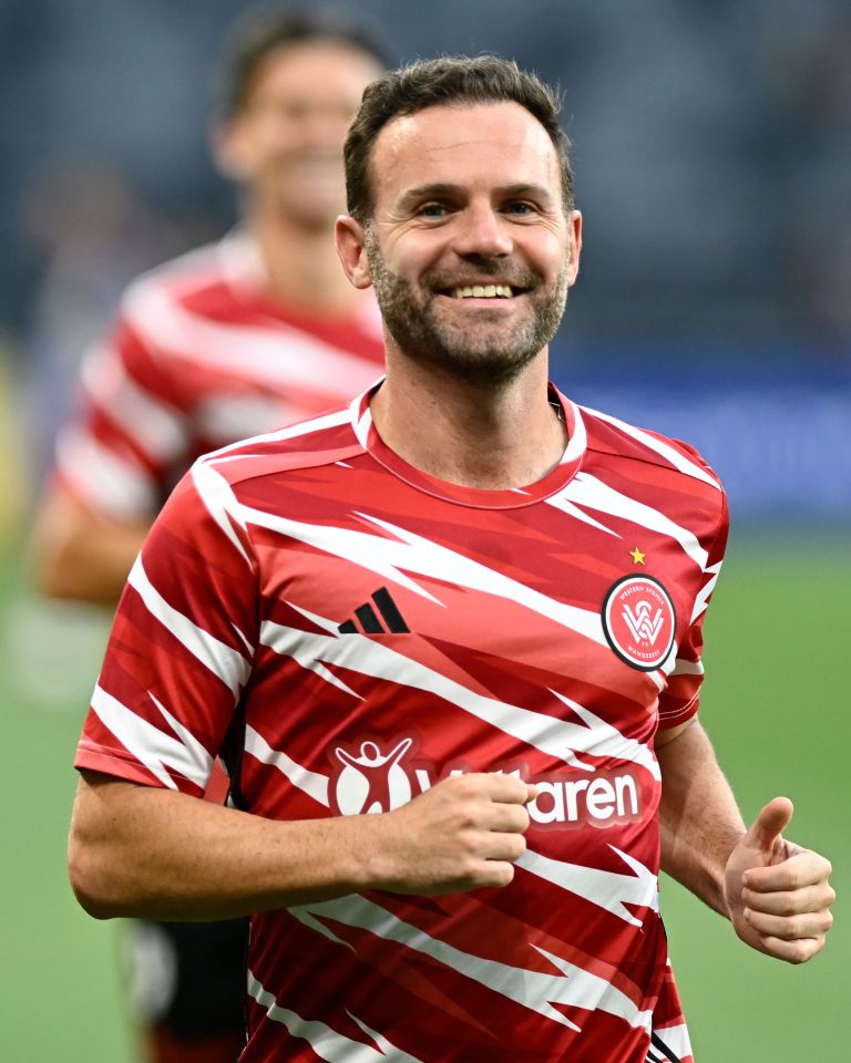 a man wearing a red and white jersey with the word aren on it