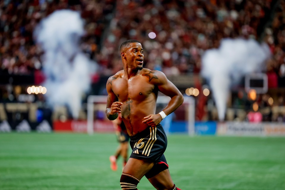 a shirtless soccer player with the number 16 on his shorts