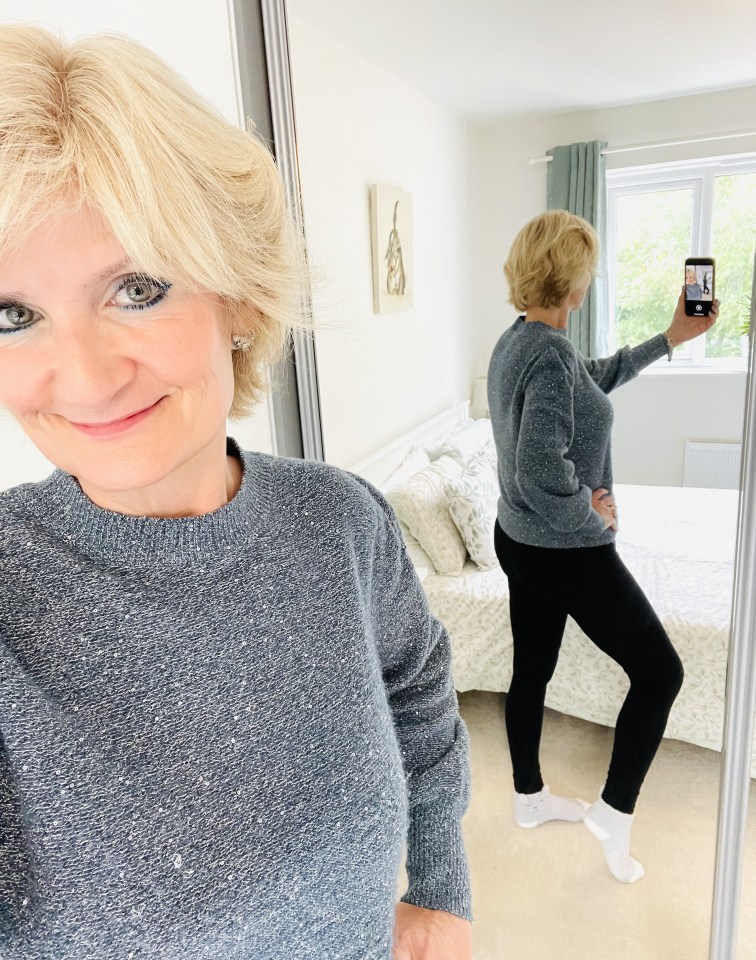 a woman taking a selfie in front of a mirror