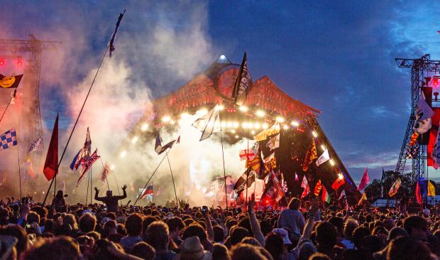 a crowd of people at a concert with flags and a sign that says ' i love you ' on it