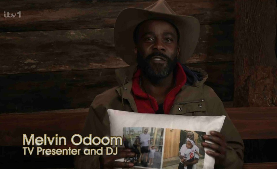 a man holding a pillow that says melvin odoom on it