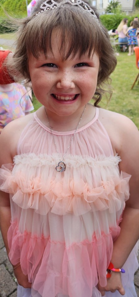 The tot beaming at her party to celebrate the end of her chemotherapy