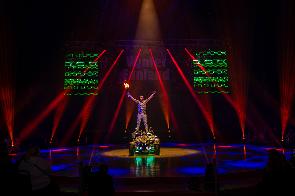 a performer on a stage with a sign that says winter finland