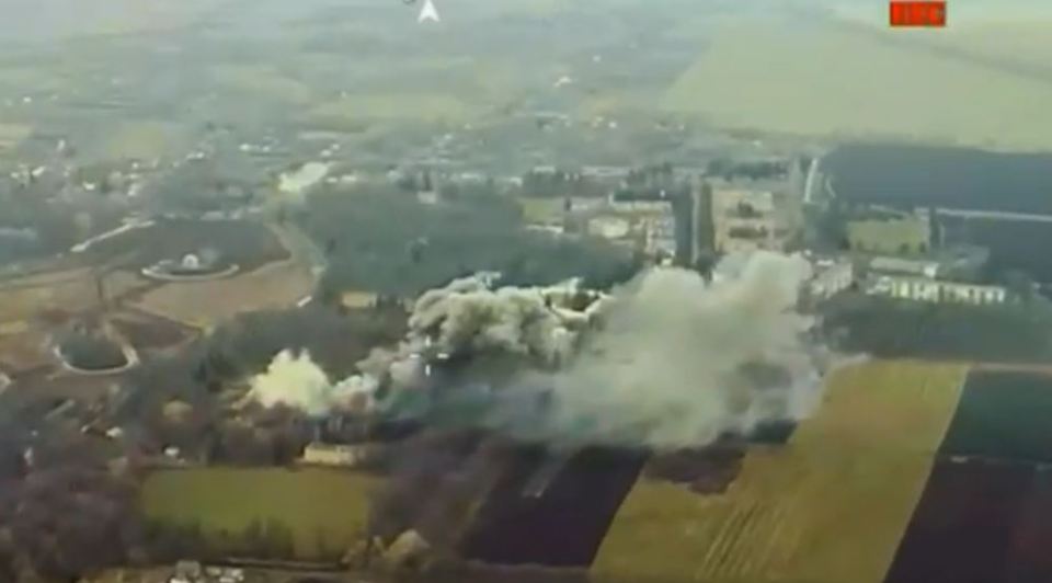 an aerial view of a large amount of smoke coming out of a building