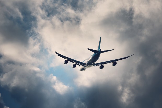 an airplane is flying through a cloudy sky