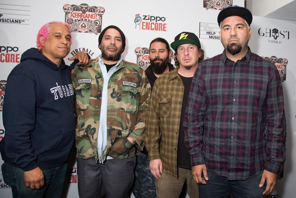 a group of men standing in front of a red carpet that says zippo encore