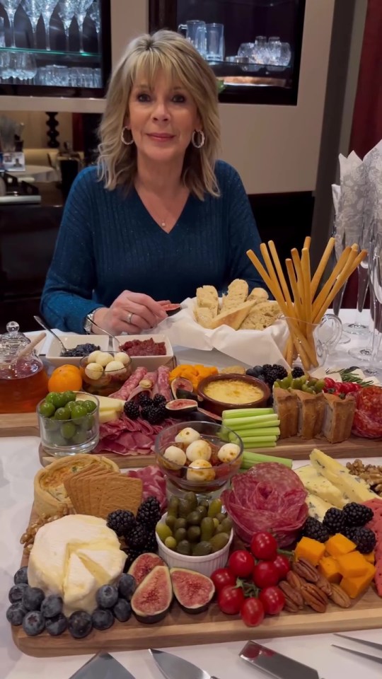 a woman sitting at a table with a tray of food