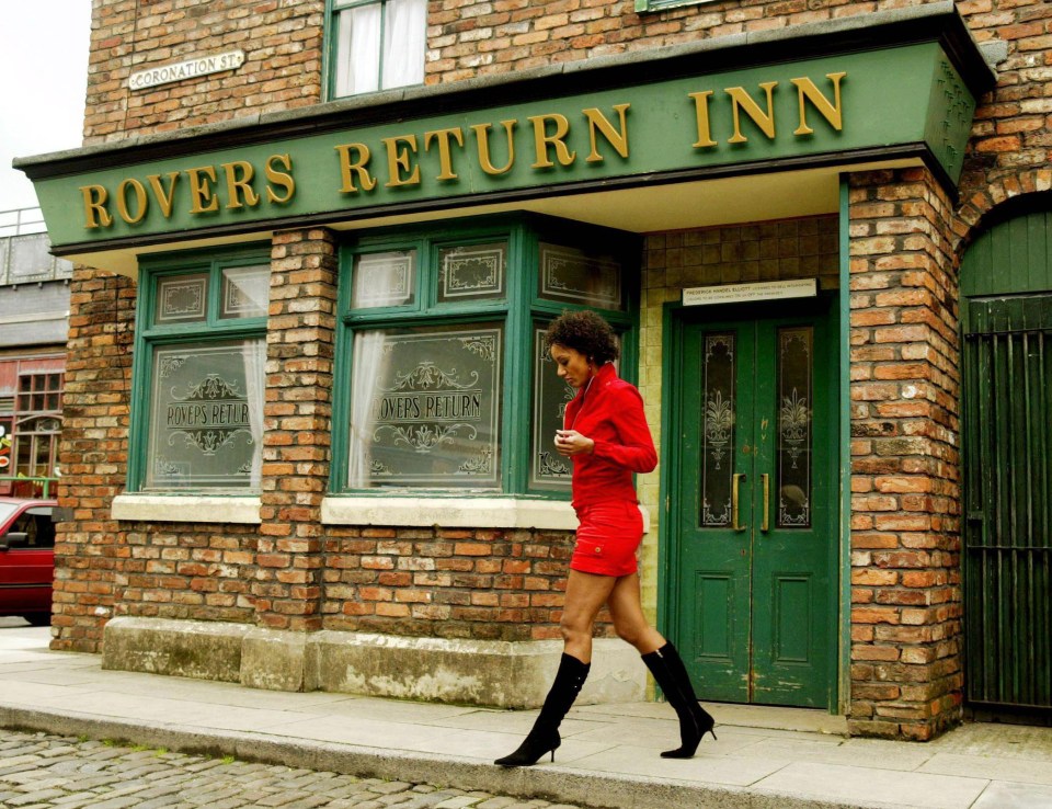 a woman in a red dress walks past the rovers return inn