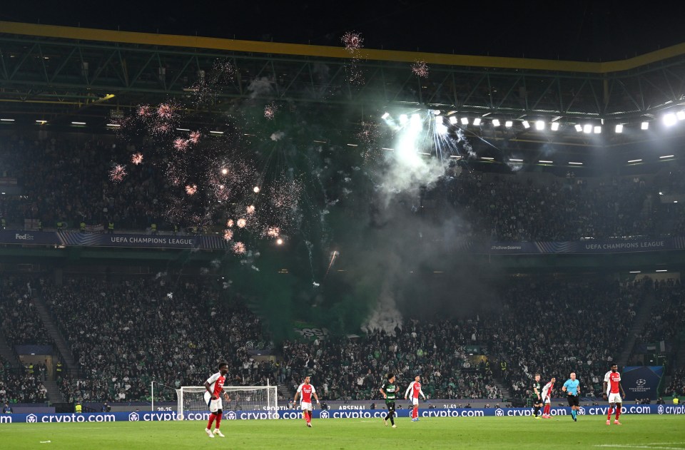 Sporting fans set off fireworks during the first half