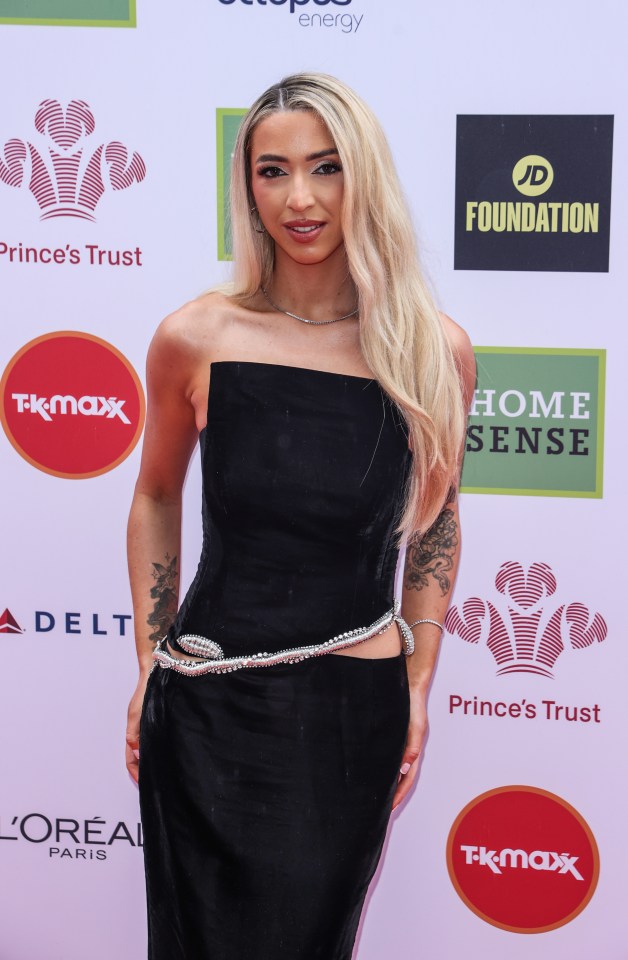 a woman stands on a red carpet in front of a jd foundation logo