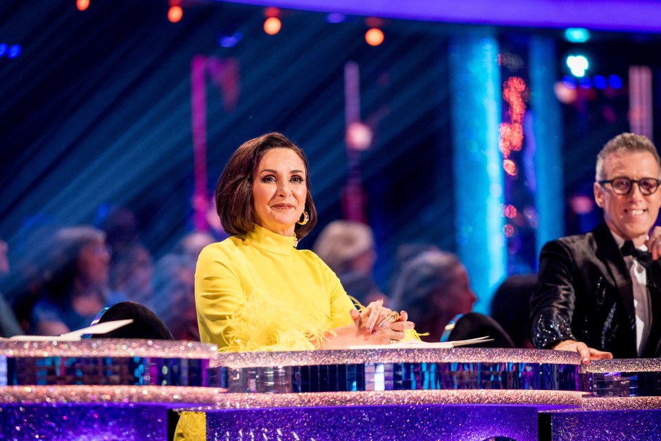 a woman in a yellow top sits next to a man in a tuxedo