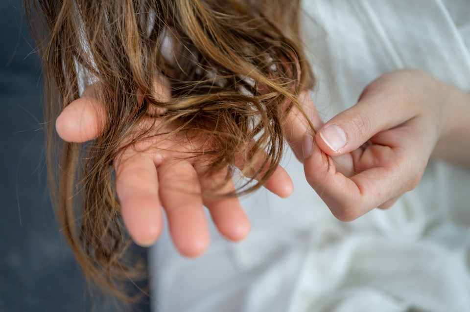 a woman is holding her hair in her hands