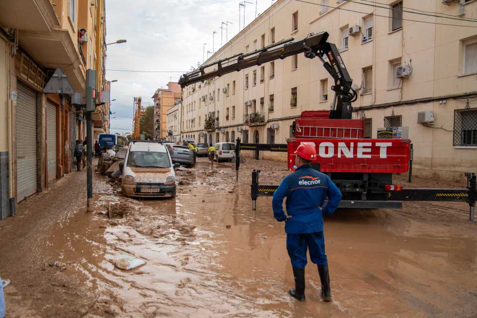 a man stands in front of a red onet truck