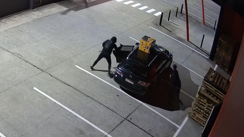 The thieves don't seem to be in much of a rush as they load their stolen items into the car