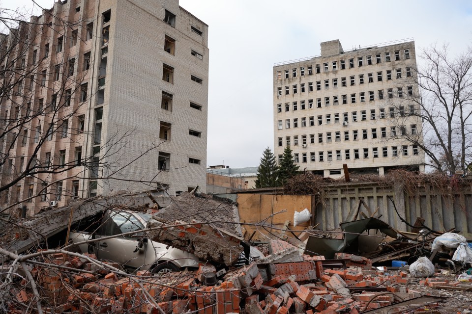 A car lies wrecked under the rubble of a building destroyed by a Russian missile strike on the Kyivskyi district in Kharkiv, Ukraine