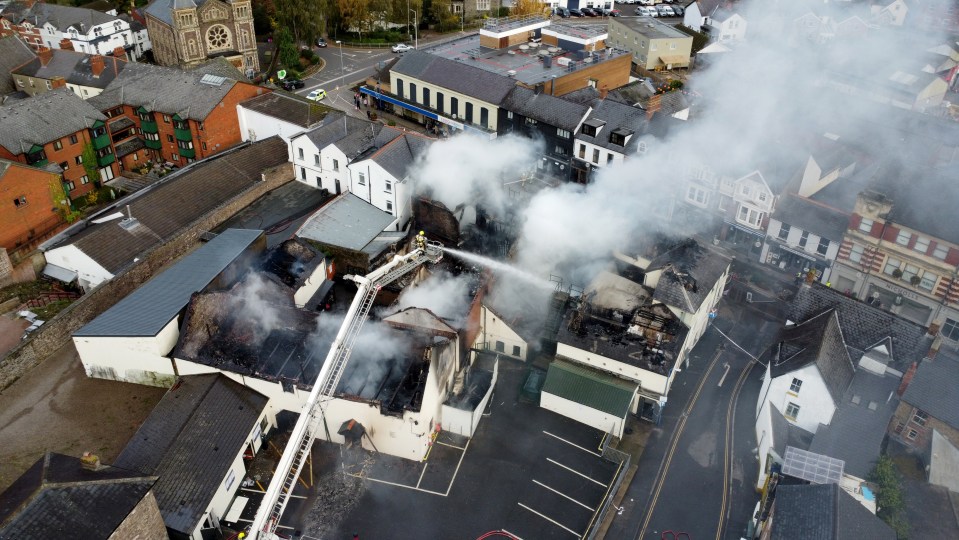 A huge fire tore through a town centre building with homes evacuated in panic