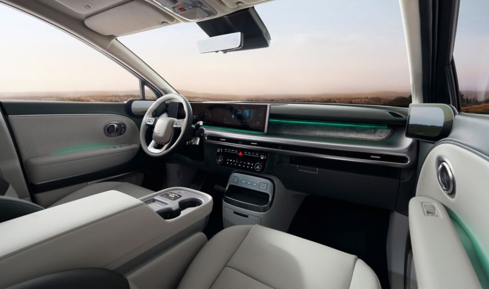 the interior of a car with a steering wheel and dashboard