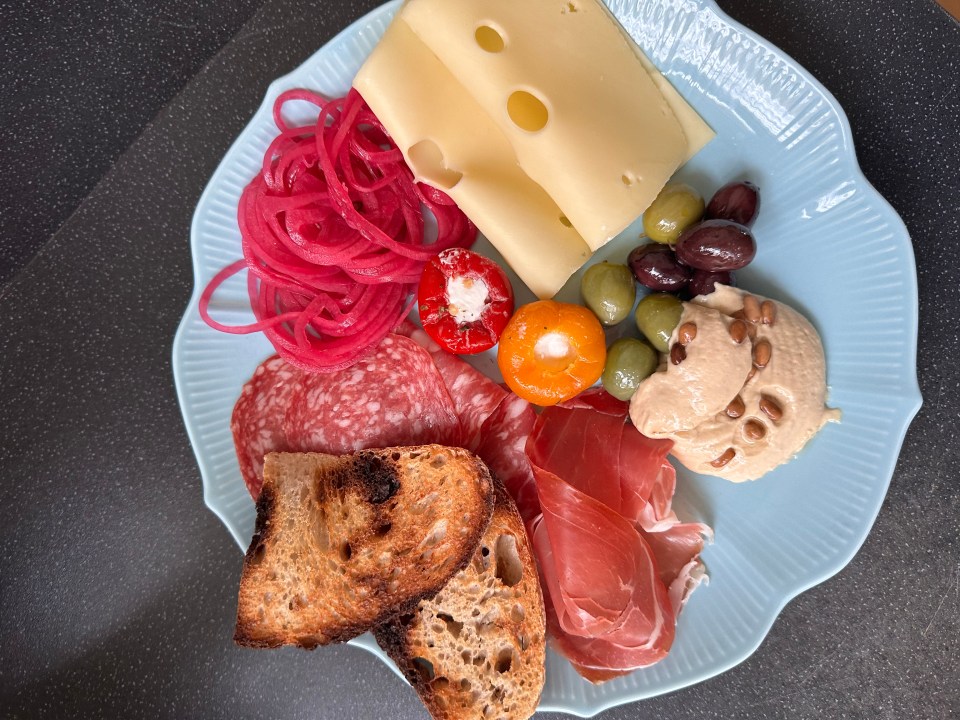 For lunch, Olivia eats buffet-style with feta, salad, and Parma ham