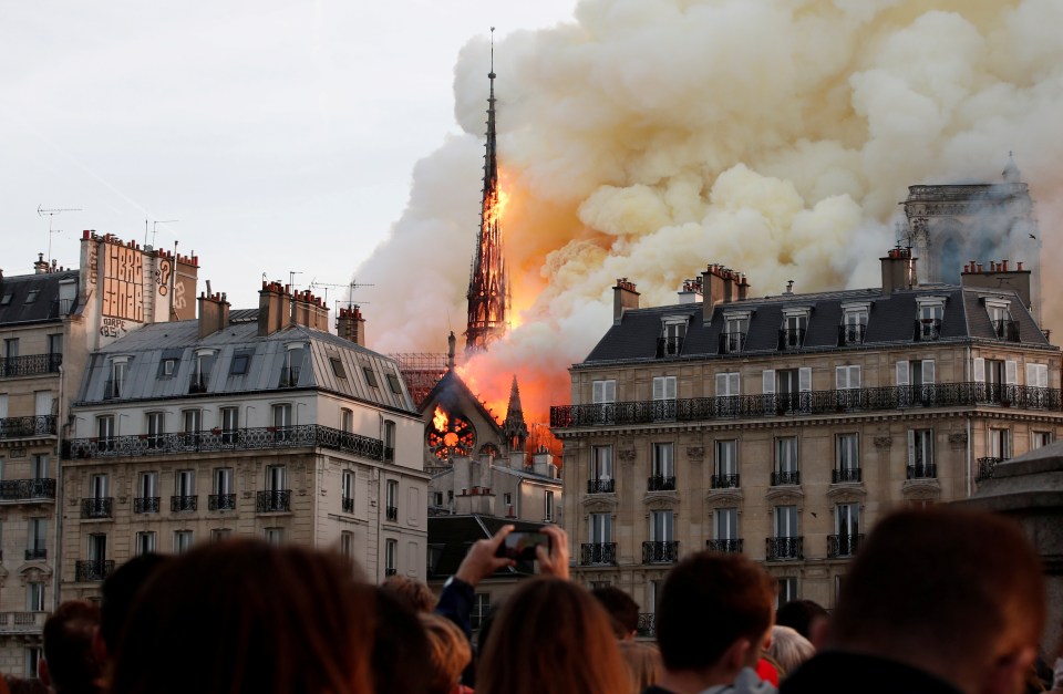 Smoke billows as fire engulfs the spire of Notre Dame Cathedral in Paris, France