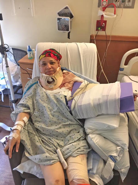 a woman in a hospital gown is laying in a hospital bed